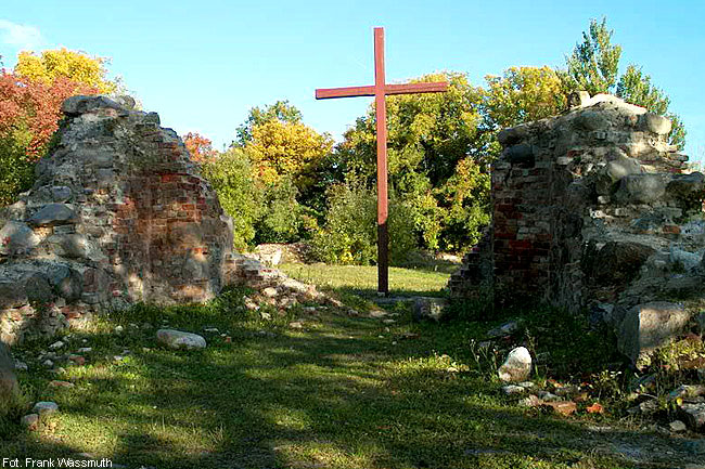 Drewniany krzyż upamiętnia miejsce po dawnym kościele